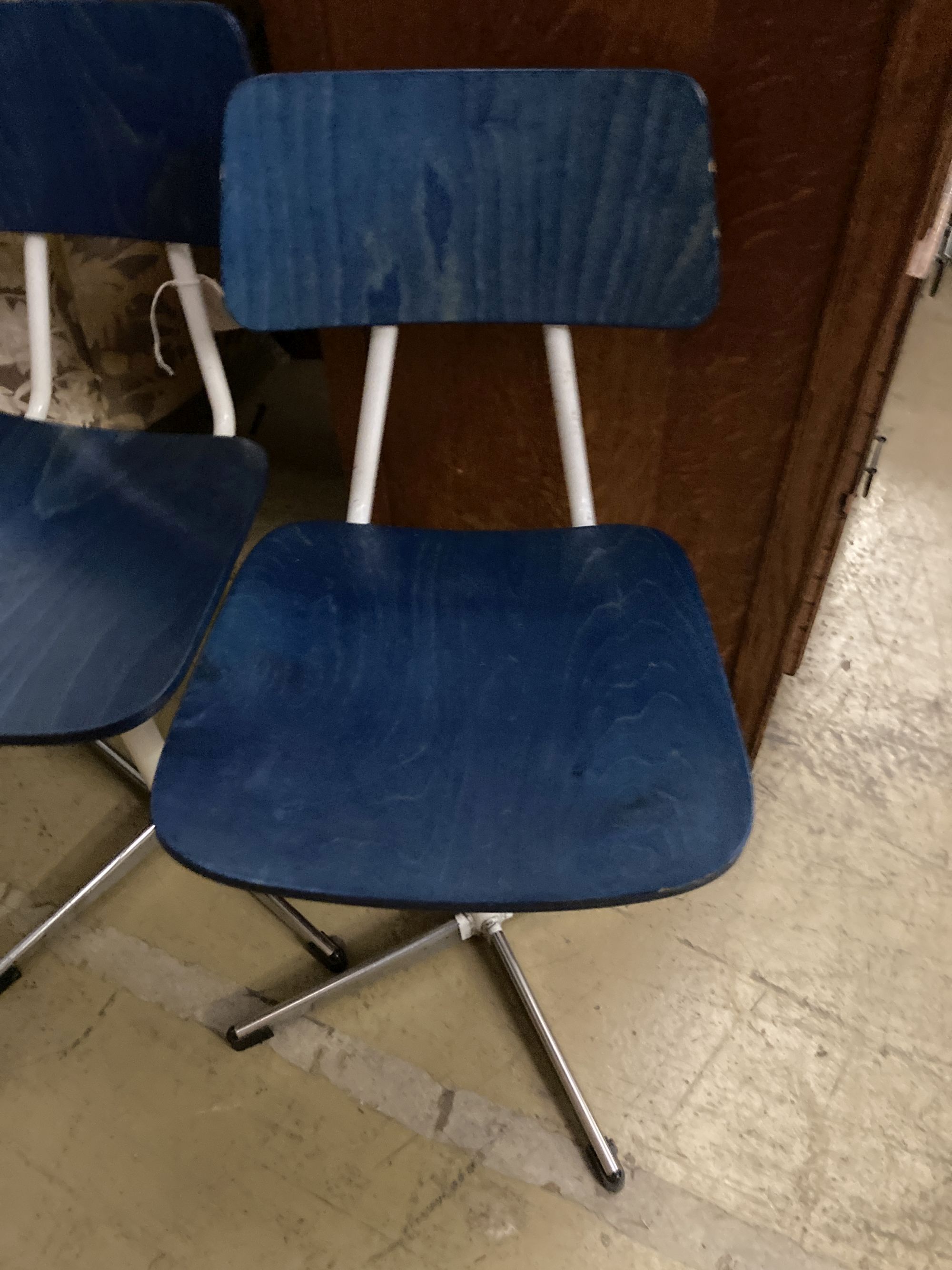 A set of three mid century stained beech and metal childs swivel chairs